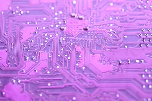 A close up shot of the backside of a computer circuit board, also known as a motherboard.