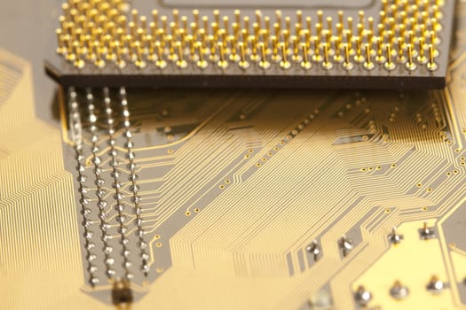 A close up shot of the backside of a computer circuit board, also known as a motherboard.