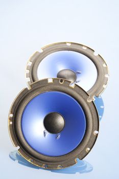 Two blue speakers on blue background