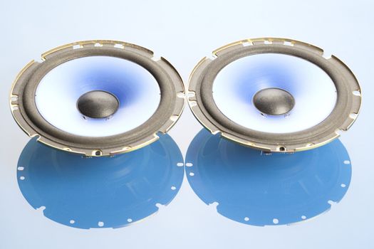 Two blue speakers on blue background