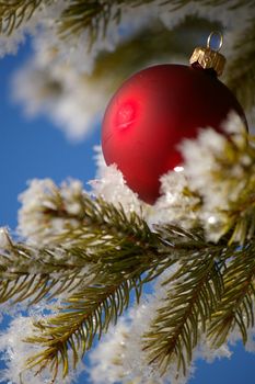 red bauble christmas ball ornament outside in a snowy winter scene