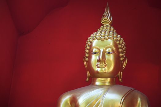 Golden Buddha against a red background - horizontal format