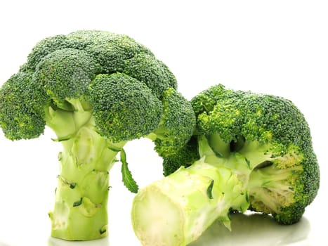 Broccoli isolated towards white, one standing, and one laying