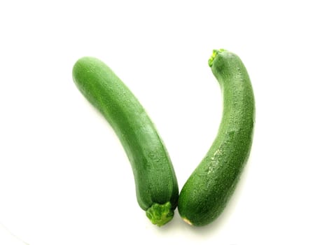 Whole zucchini vegetable isolated towards white background
