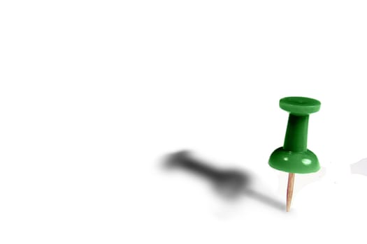 A green tack standing up with shadow, white copyspace