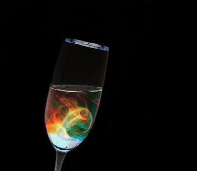 A leaning glass with futuristic looking liquid inside