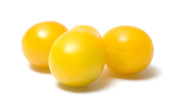 Three yellow tomato on a white background.