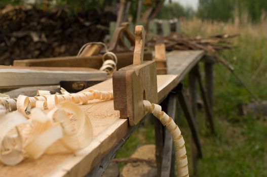 Closeup shot of old wooden plane on the workbench.