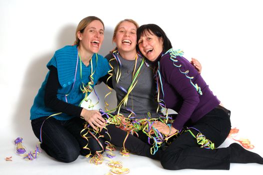 Two young women and her mother celebrating New year's eve. Shot taken in front of white background