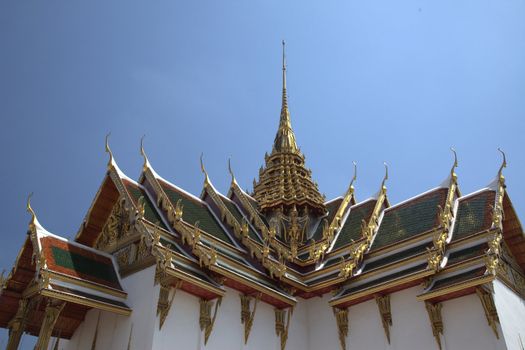 Roof of a temple with gods against a blue sky - horizontal

