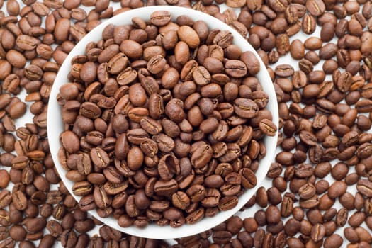 Close up of Coffee beans in bowl and around a white bowl