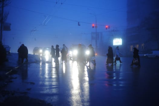 commuters crossing the street  during evening rush hour