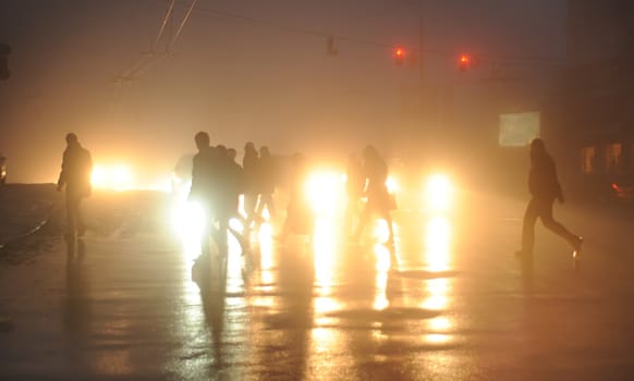 commuters crossing the street  during evening rush hour