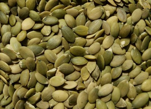 Natural pealed pumpkin seeds in background compositions