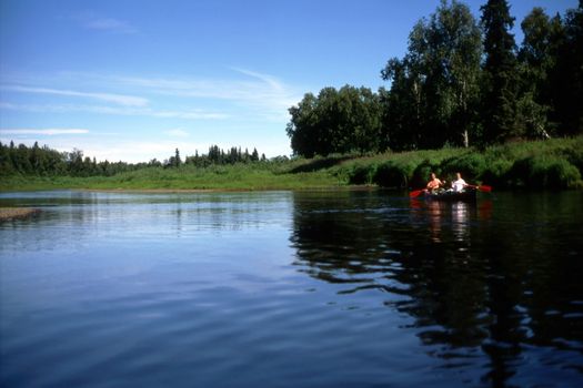 Two persons rowing in the lake in Alaska