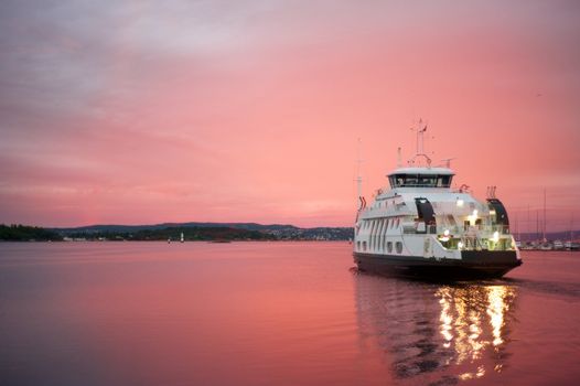 Cruise liner floating away from the Olso harbor at dawn