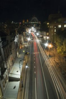 night photo of Sydney district The Rocks, Harbour Bridge in background