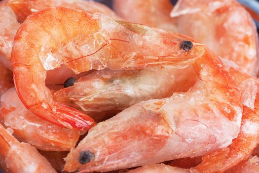 Closeup view of a heap of frozen shrimps