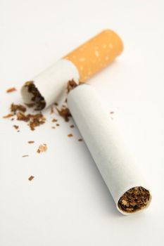 single broken cigarette on white background, tobacco