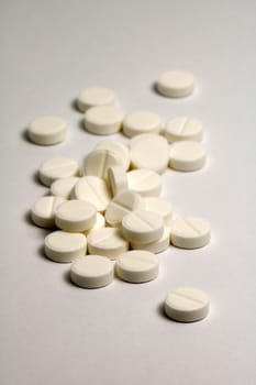 several pills, distance blur, grey and white color