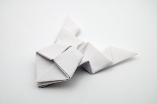 Origami frog on white background