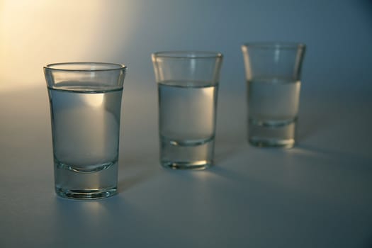 three glasses full of alcohol, distance blur