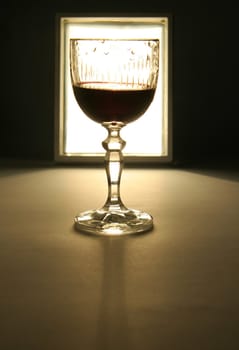 glass of wine silhouette, white light in background