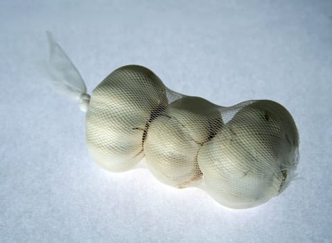 three garlic bulbs on white background