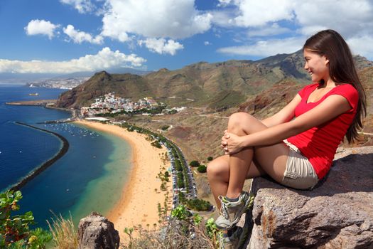 Tenerife. Woman traveler tourist looking at beach view. Playa de las Teresitas, Tenerife, Canary Islands, Spain.