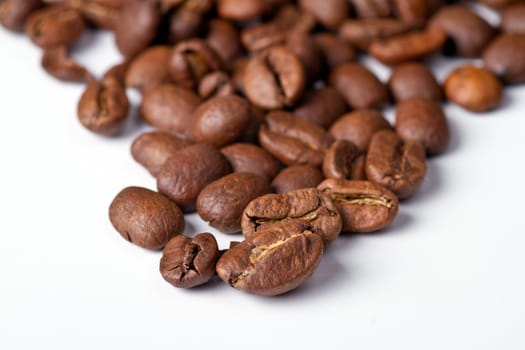 Stack of coffee beans on white background