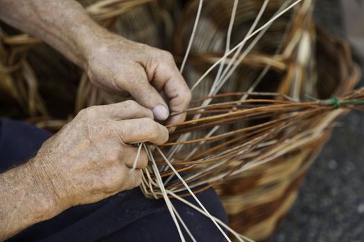 Old hands working in a basket costruction