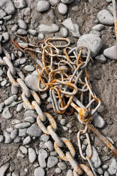 Rusty chain on the ground in a dock