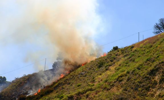 Brush fire in Ventura, California. The fire consumed 25 acres and was quickly controlled by more then 100 firefighters and water dropping helicopters.