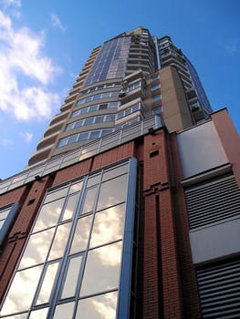 high building is abutted by roof against sky. 