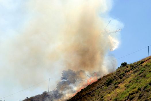 Brush fire in Ventura, California. The fire consumed 25 acres and was quickly controlled by more then 100 firefighters and water dropping helicopters.
