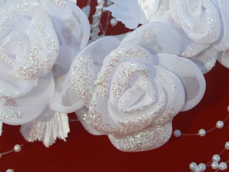 White wedding roses are decorated with beads. 