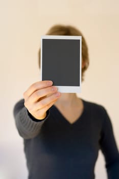 woman holding empty card in front, shallow DOF