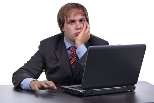 young bored business man working with is laptop