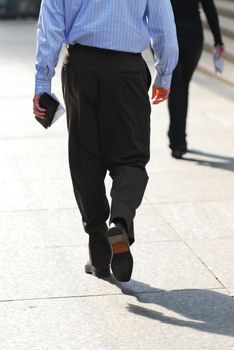 Business people walking on a busy street downtown