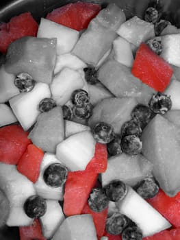 a bowl of fruit hilighting the watermelon slices.