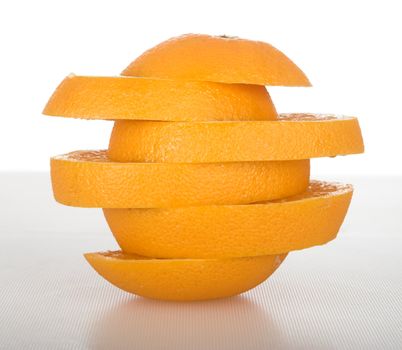 Picture of an orange in slices over a table