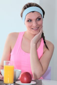 young athletic woman having breakfast at home