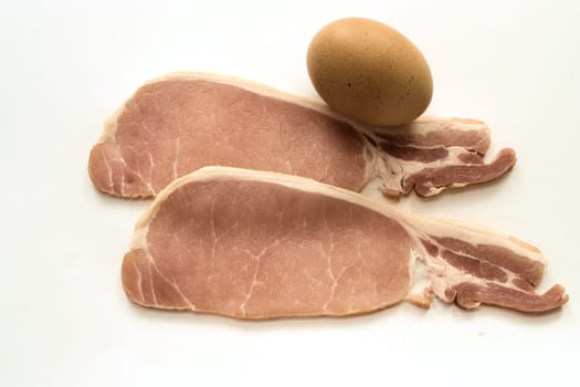 Raw bacon rashers and egg
