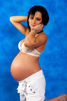 Pregnant woman on the blue mosaic background