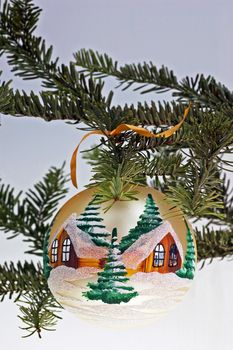 Detail of christmas tree with white glass ball.