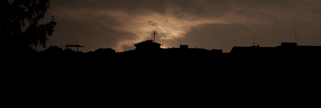 Silhouette of a city with sunset sky