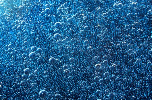 A series of bubbles under blue water