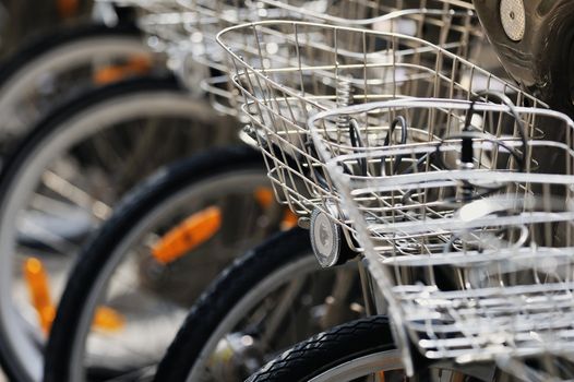 Bicycles with metallic baskets on the city street. Photo with tilt-shift lens