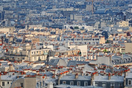 Aerial panorama above houses rooftops in a Paris