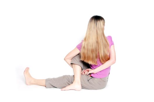 Yoga pose called "sitting half spinal twist" by young woman.